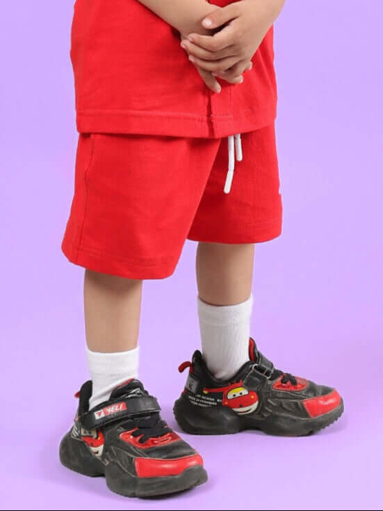 LIMBO SHORTS FOR BOYS & GIRLS RED, made to order, custom fit option available, shown on a child with sneakers, vibrant red color.