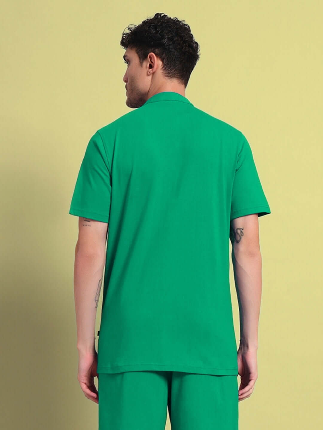 Rear view of a model wearing a green Limbo regular fit shirt, highlighting the premium cotton fabric—perfect for casual style. Made in India.