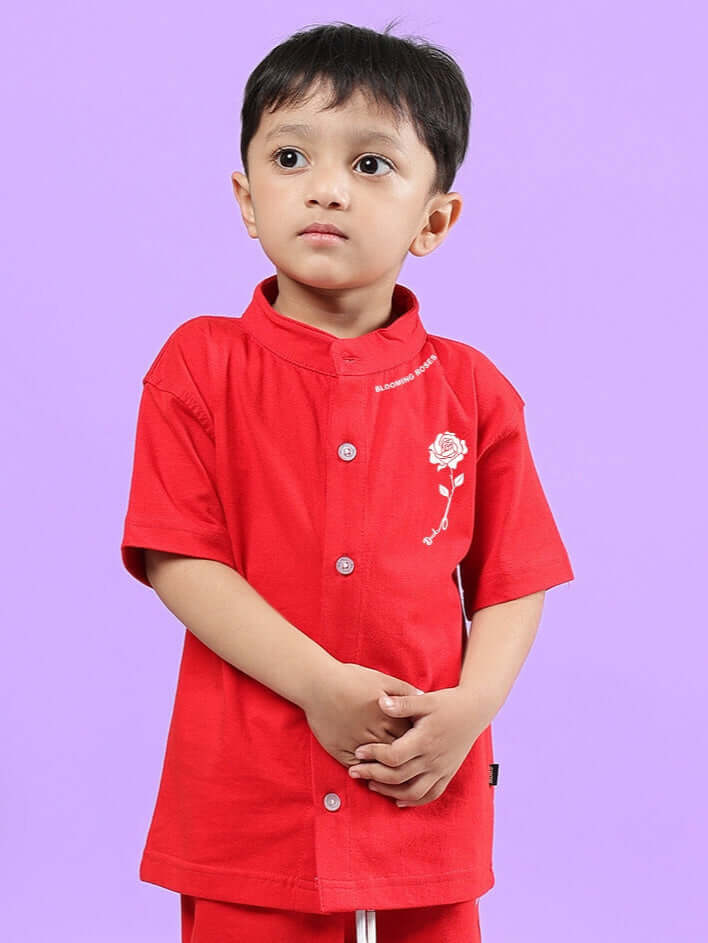Child wearing a red LIMBO shirt for boys and girls, showcasing a made-to-order article by DUDS.