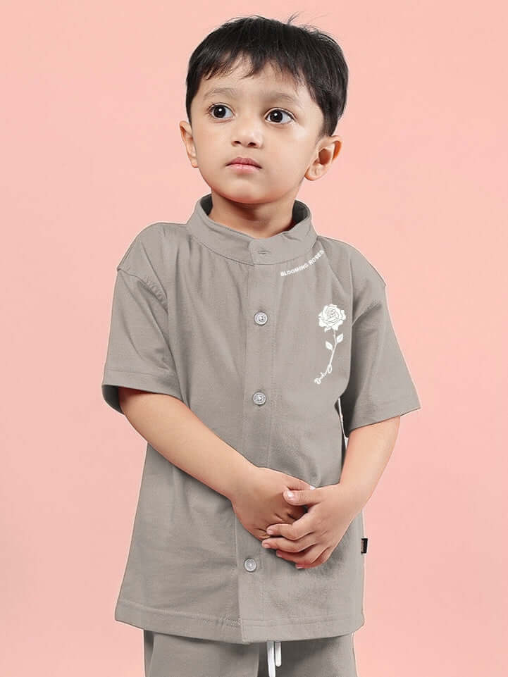 LIMBO SHIRT FOR BOYS & GIRLS GREY showcasing modern kids fashion on a young model against a soft pink background.