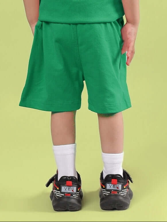 Child wearing LIMBO SHORTS FOR BOYS & GIRLS GREEN, showcasing comfortable and breathable cotton-blend fabric ideal for everyday activities.