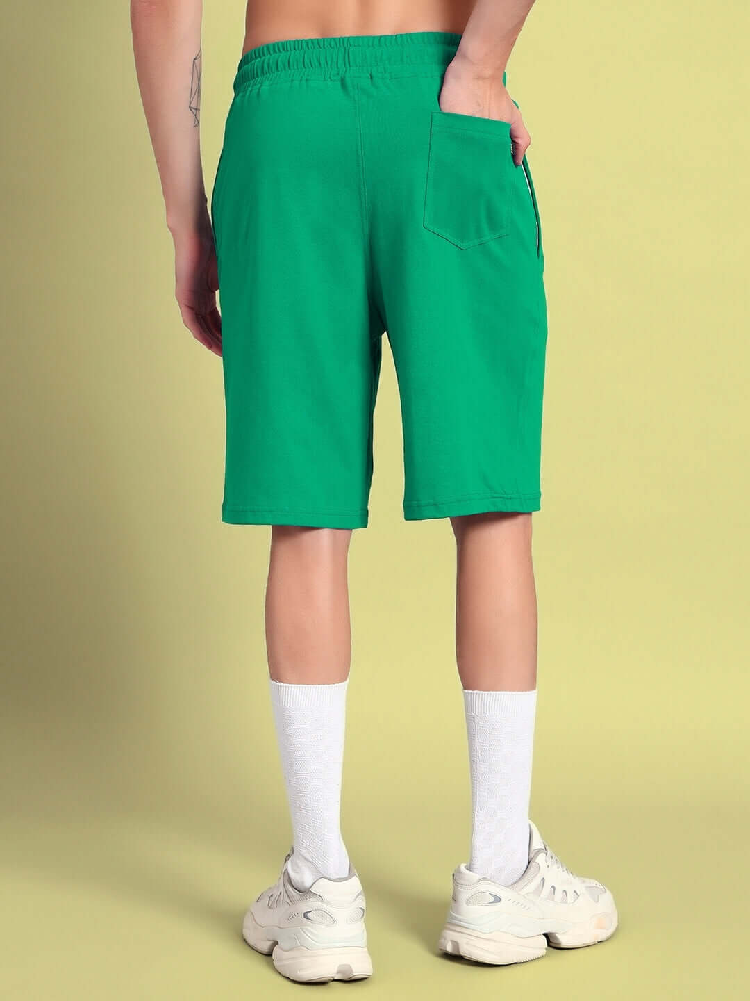 Back view of a person wearing green LIMBO summer shorts showcasing the fit and style. Ideal for customizable and prepaid orders.