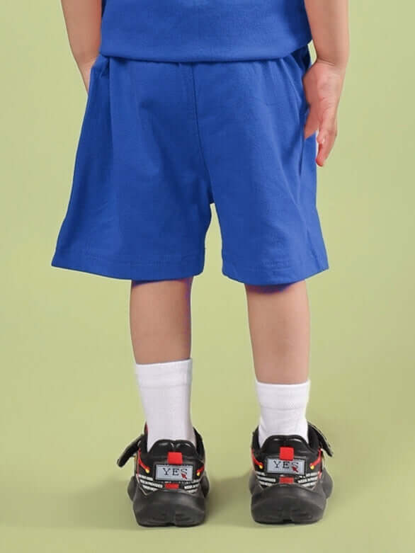 Child wearing LIMBO SHORTS FOR BOYS & GIRLS BLUE, showcasing breathable cotton-blend fabric, perfect for active play and comfort.