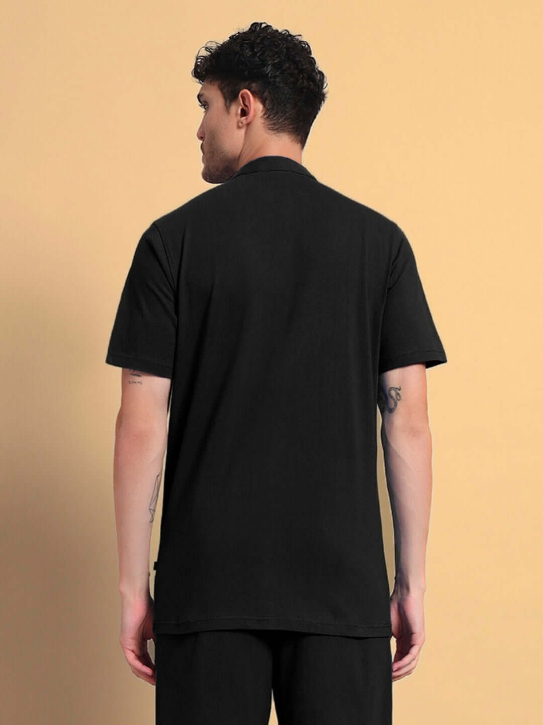 Back view of man wearing black Limbo regular fit shirt, made from premium cotton French terry lycra, showcasing the fit and texture.