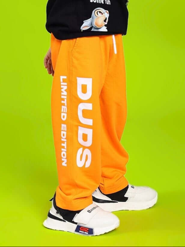 LIMITED EDITION JOGGER FOR BOYS AND GIRLS ORANGE with bold lettering against vibrant backdrop.