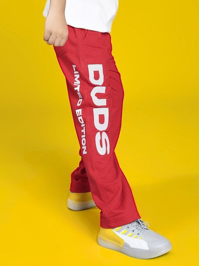 Child wearing LIMITED EDITION JOGGER FOR BOYS AND GIRLS RED with bold white text, displaying sunny citrus vibrance, ideal for active play.