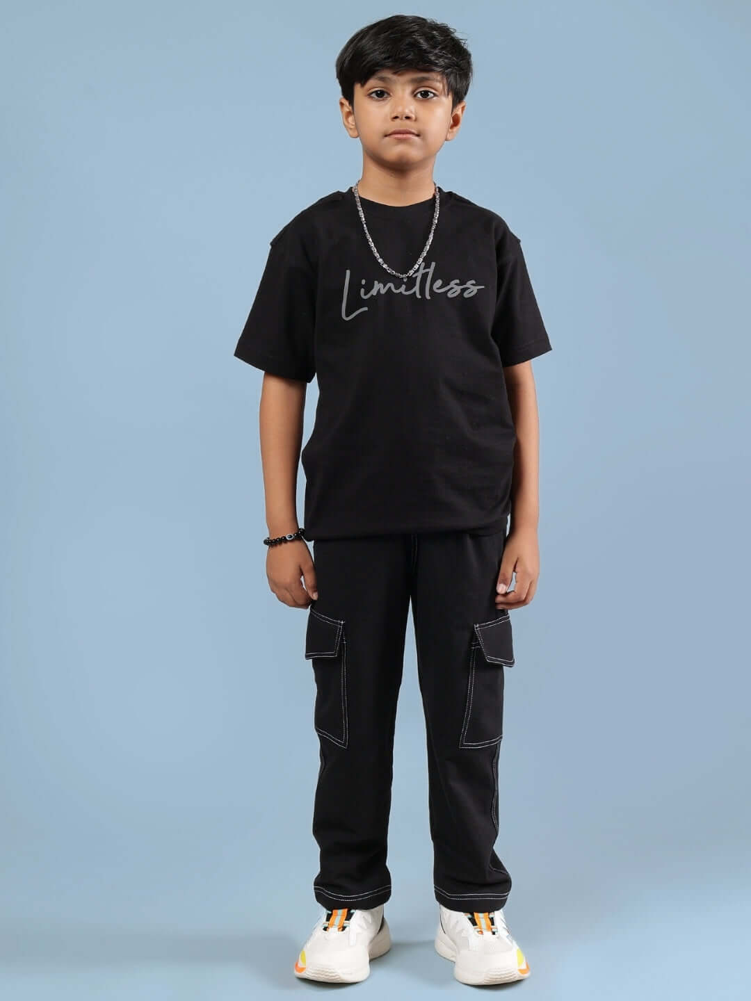 Child wearing Limitless Co-Ord for Boys Girls Black, featuring a sleek black t-shirt and matching pants, promoting comfort and ambition.