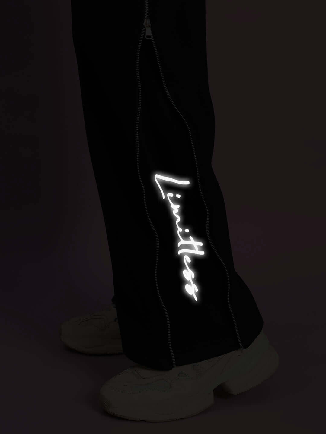 Close-up of Limitless Fleece Reflector Co-ord in Black showcasing reflective design detail on pant leg.