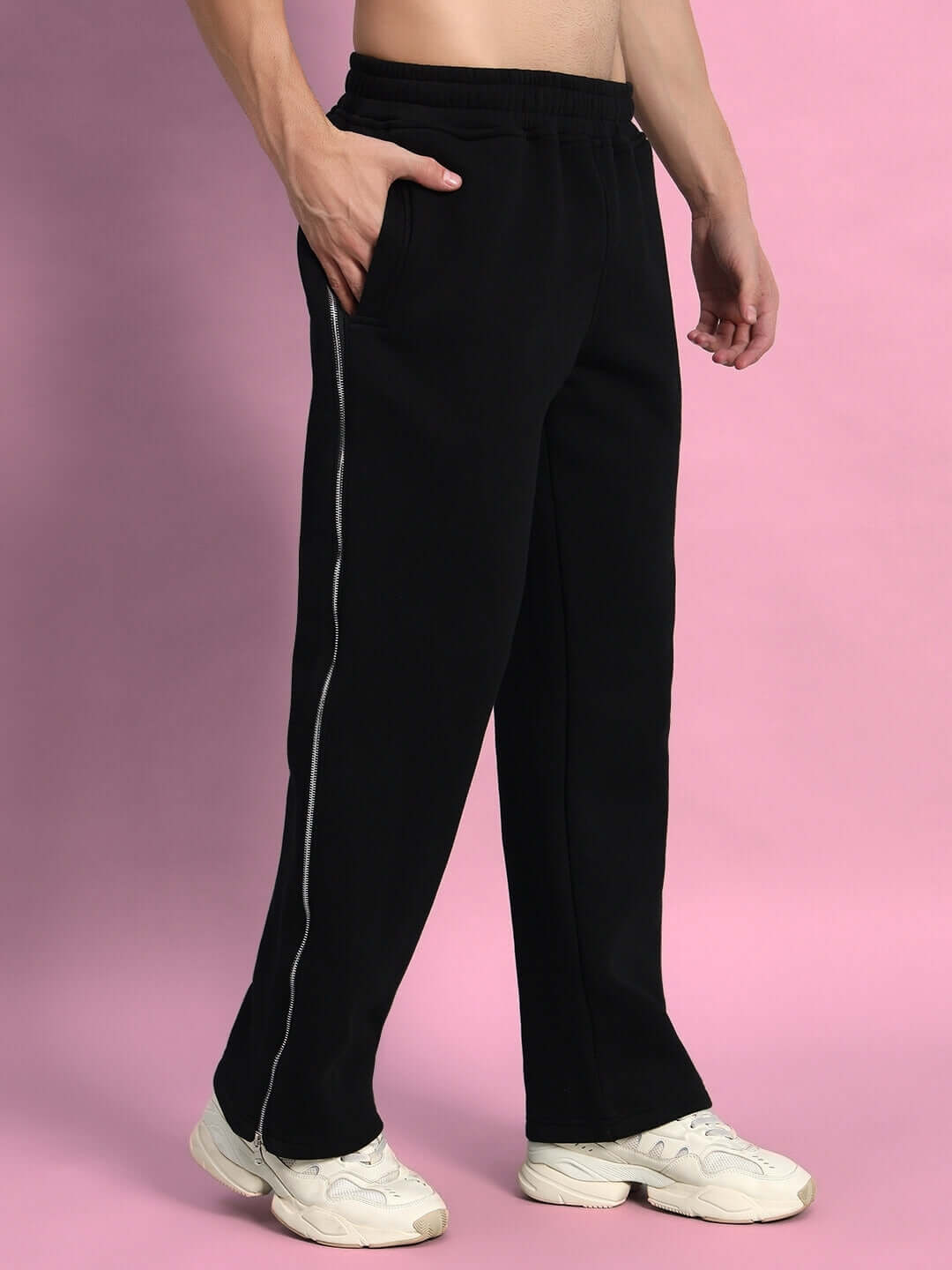 Man wearing LIMITLESS FLEECE REFLECTOR JOGGER BLACK with reflective detailing.