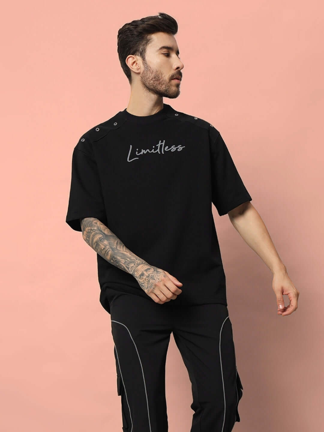 Model wearing a Limitless black oversized t-shirt, crafted from premium cotton French terry with elastane, ideal for a stylish casual look.