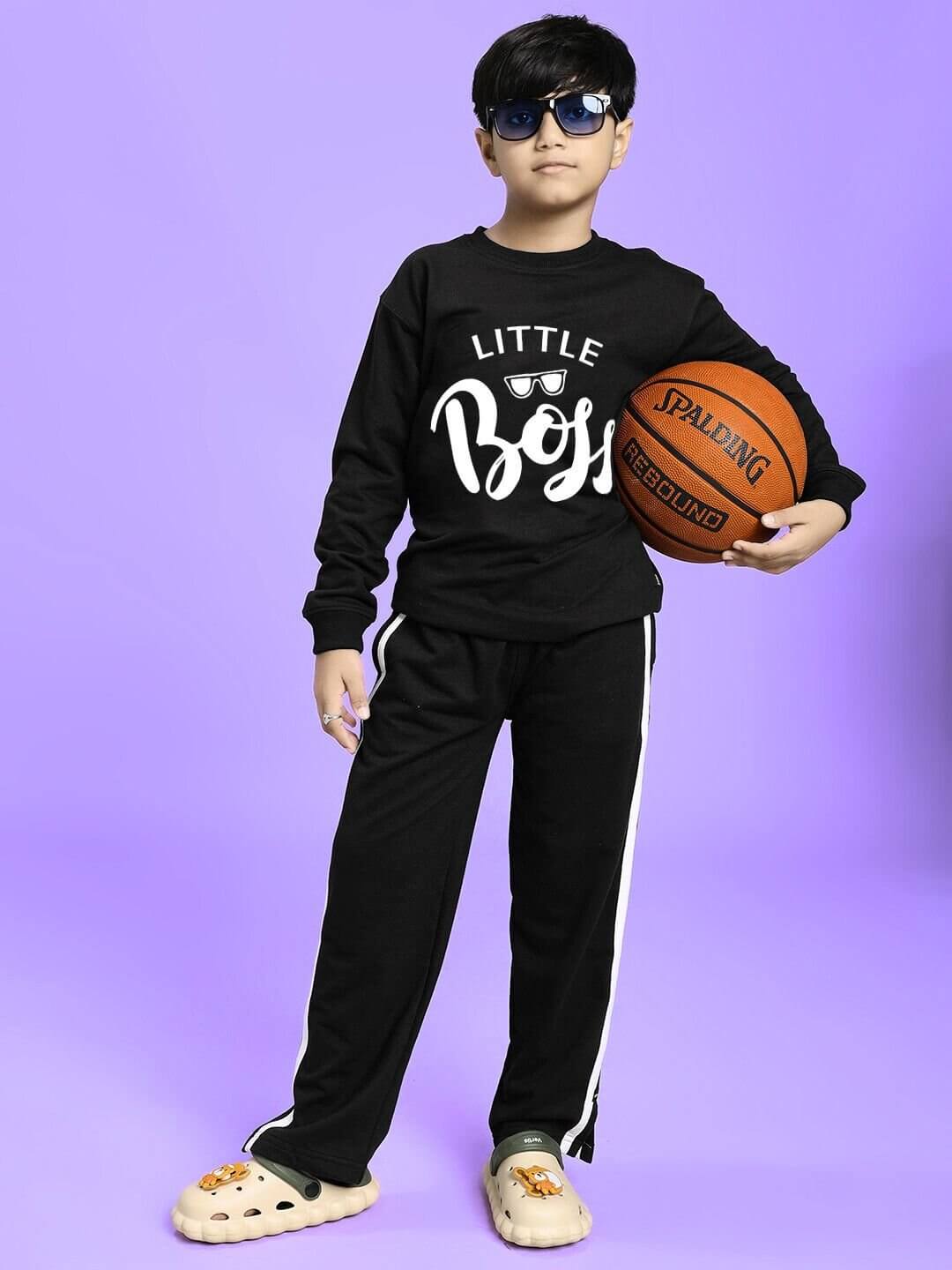 Child wearing LITTLE BOSS CO-ORD FOR BOYS AND GIRLS BLACK set holding a basketball, showcasing confident and stylish kids' fashion.