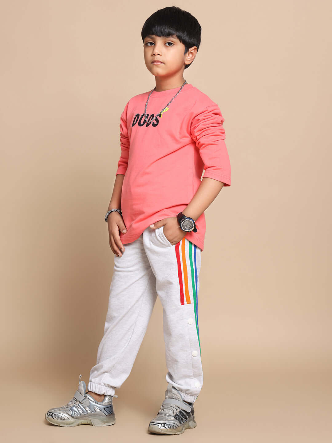 Child wearing Little Things Co-ord for Boys & Girls in Peach-M Grey with colorful striped sweatpants, showcasing casual style.