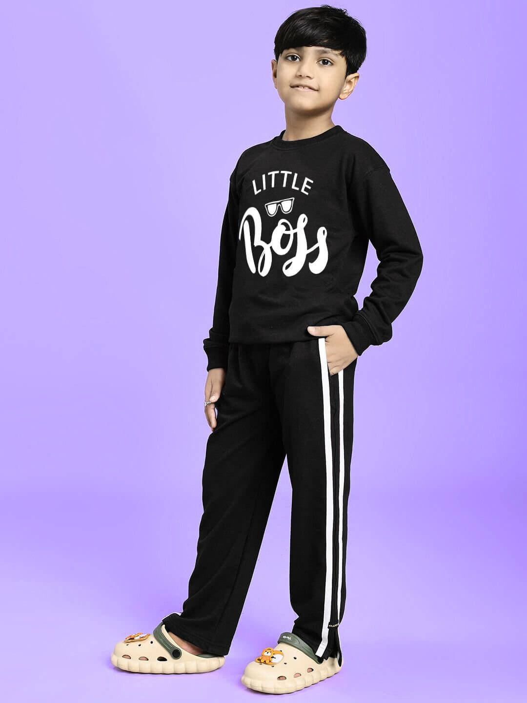 Child wearing LITTLE BOSS CO-ORD FOR BOYS AND GIRLS BLACK with a stylish top and pants set against a purple background.