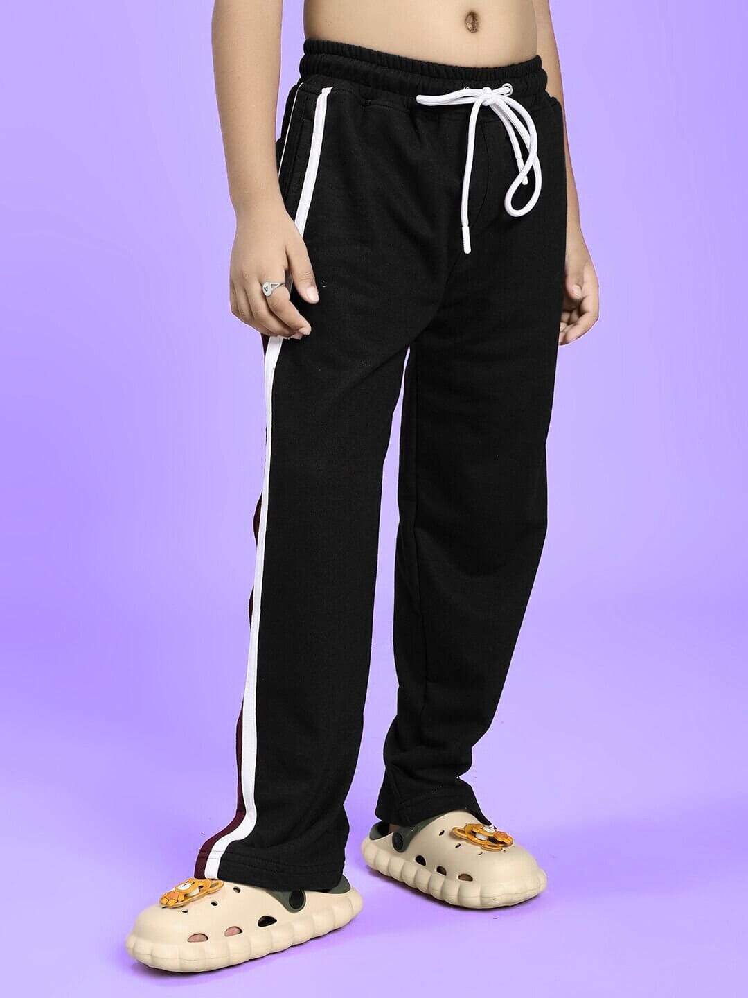 Child wearing LITTLE BOSS CO-ORD FOR BOYS AND GIRLS BLACK pants, showcasing confident style in sleek black with white stripe details.