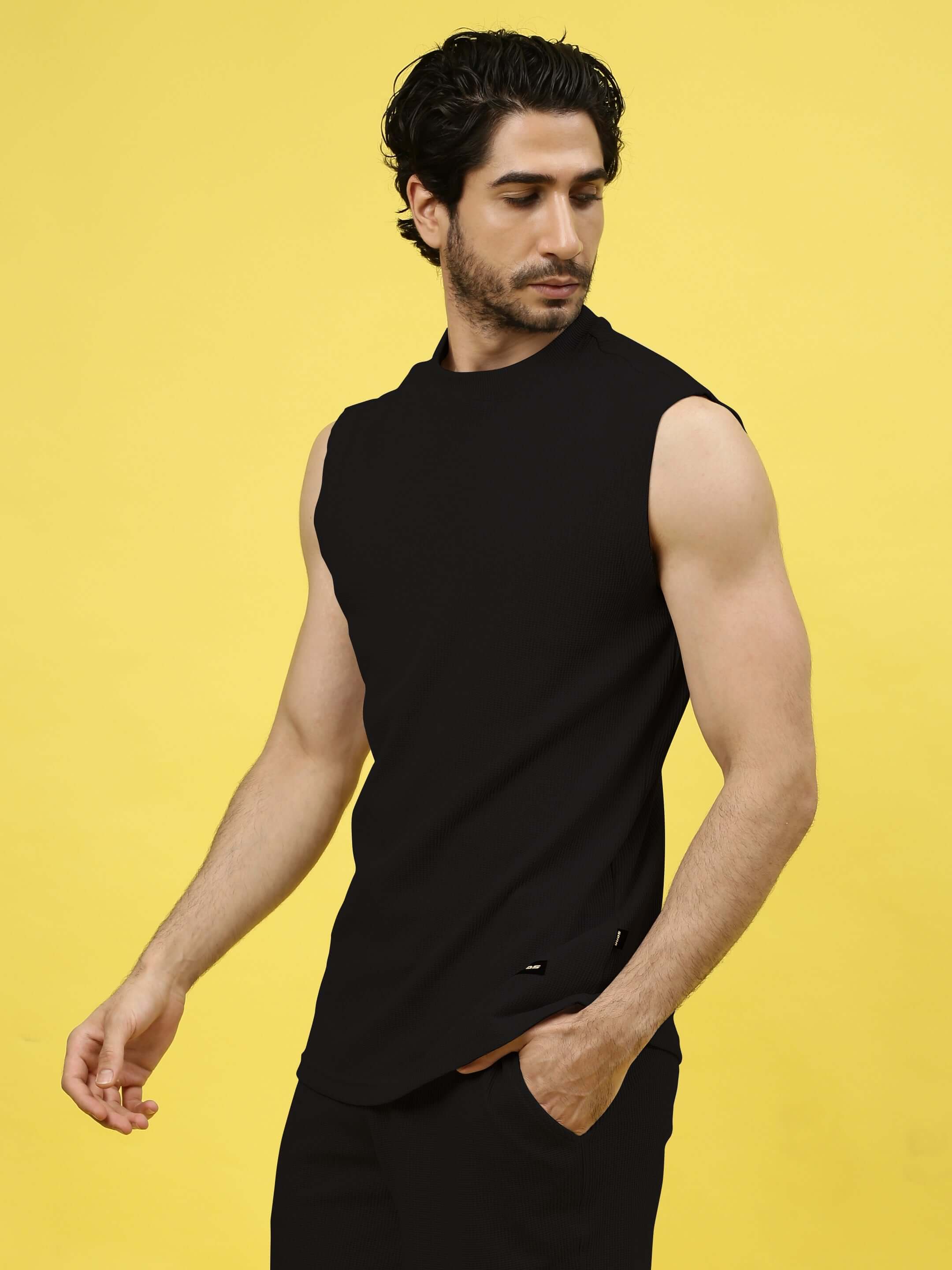 Man modeling LOW-KEY SOLID CO-ORD SET in black, highlighting premium heavy gauge waffle fabric, perfect for stylish comfort.