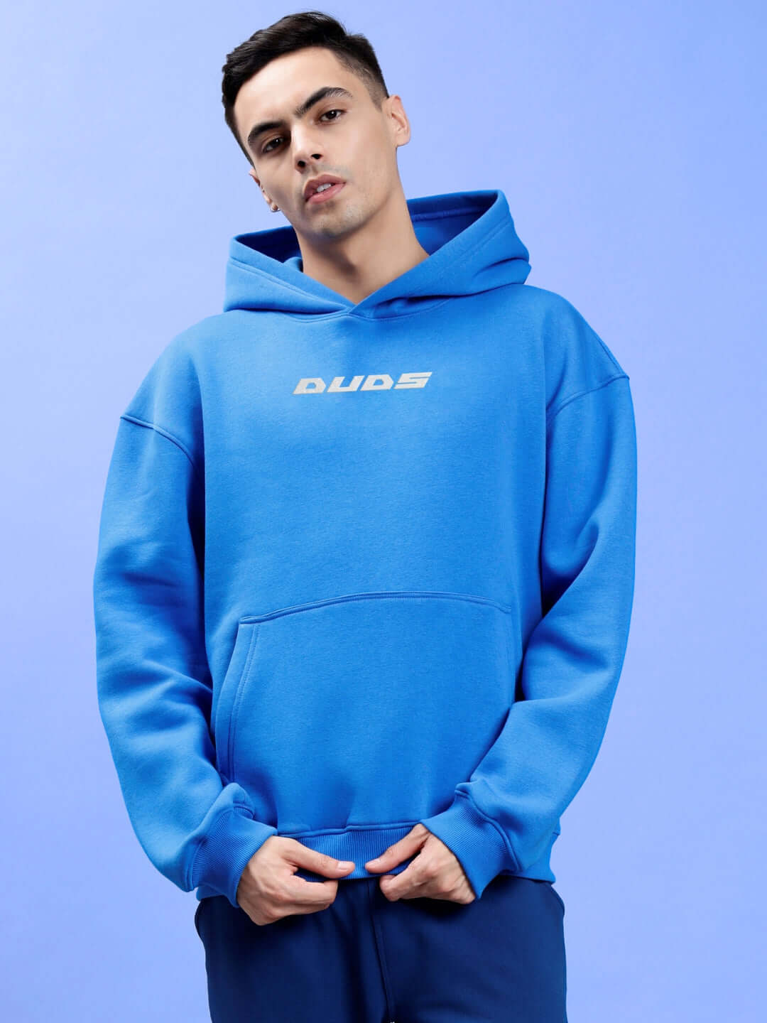 Model wearing LUNA FLECCE OVERSIZED HOODIE ROYAL BLUE, showcasing its oversized fit and premium fleece fabric against a blue background.