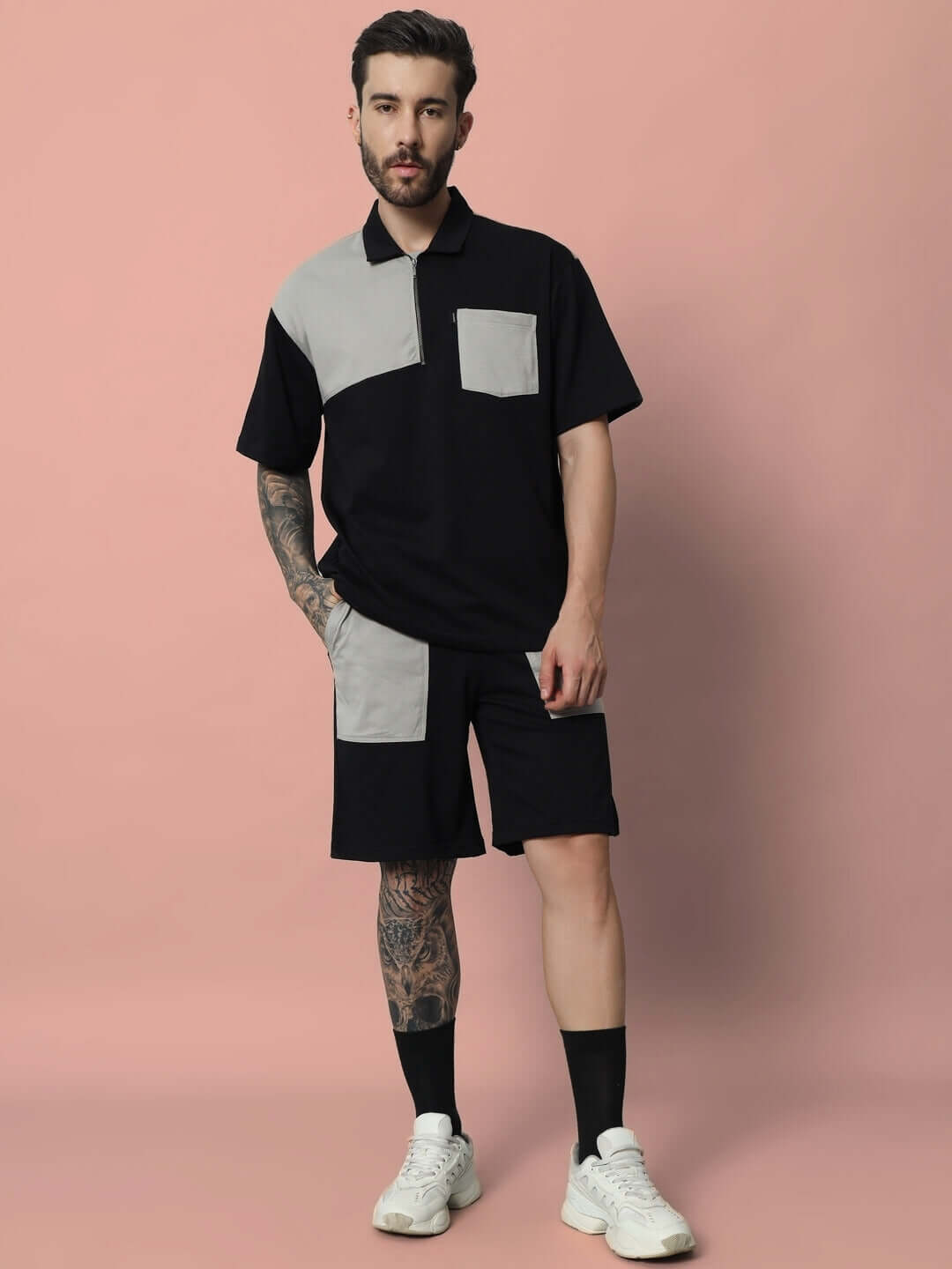Model wearing black grey LUSTRE CO-ORD SET made from premium cotton French terry lycra, showcasing front pocket design on pink backdrop.