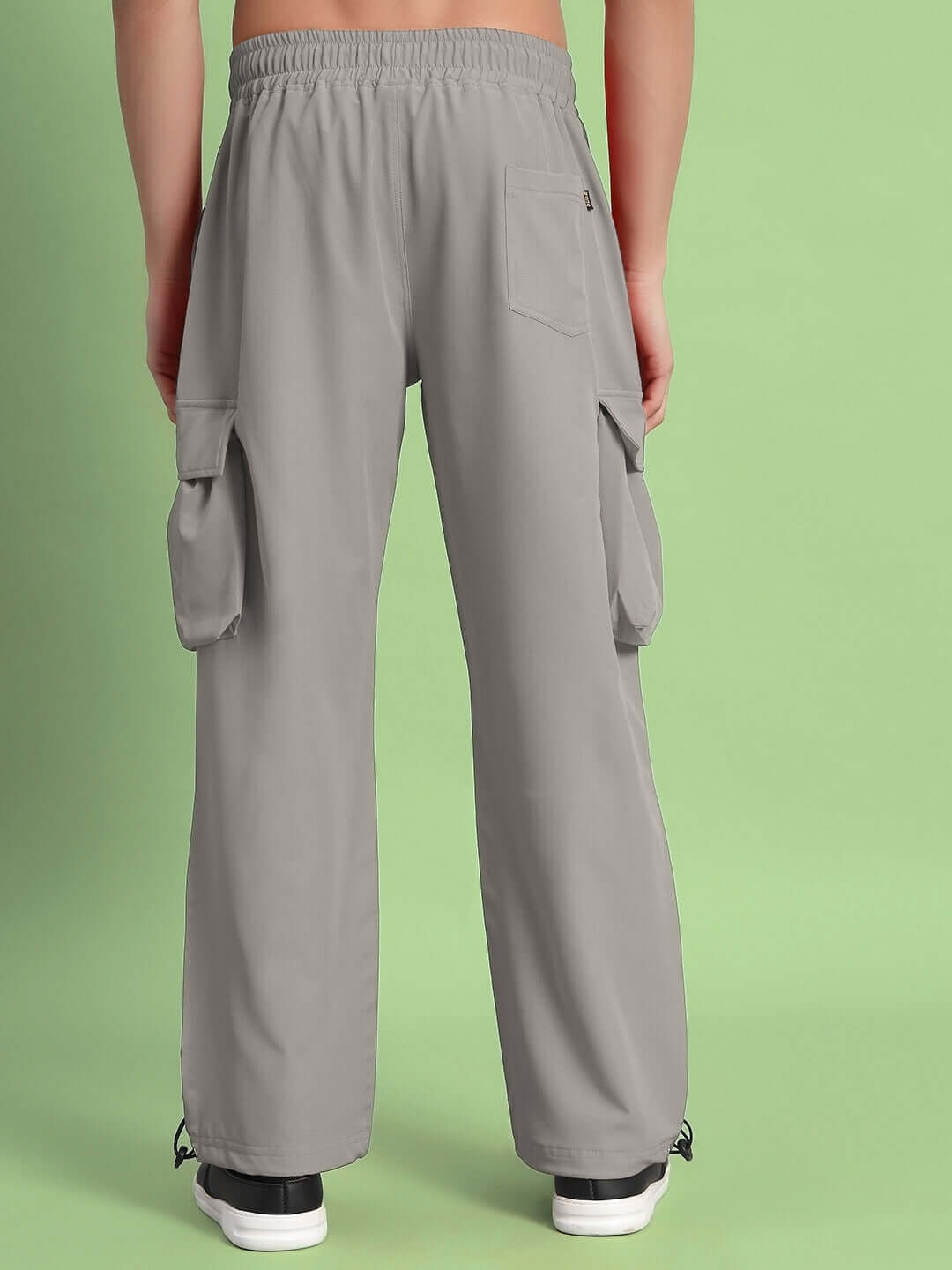 Back view of Mabel relaxed fit cargo pants in grey, featuring spacious pockets and customizable size options for a perfect fit.