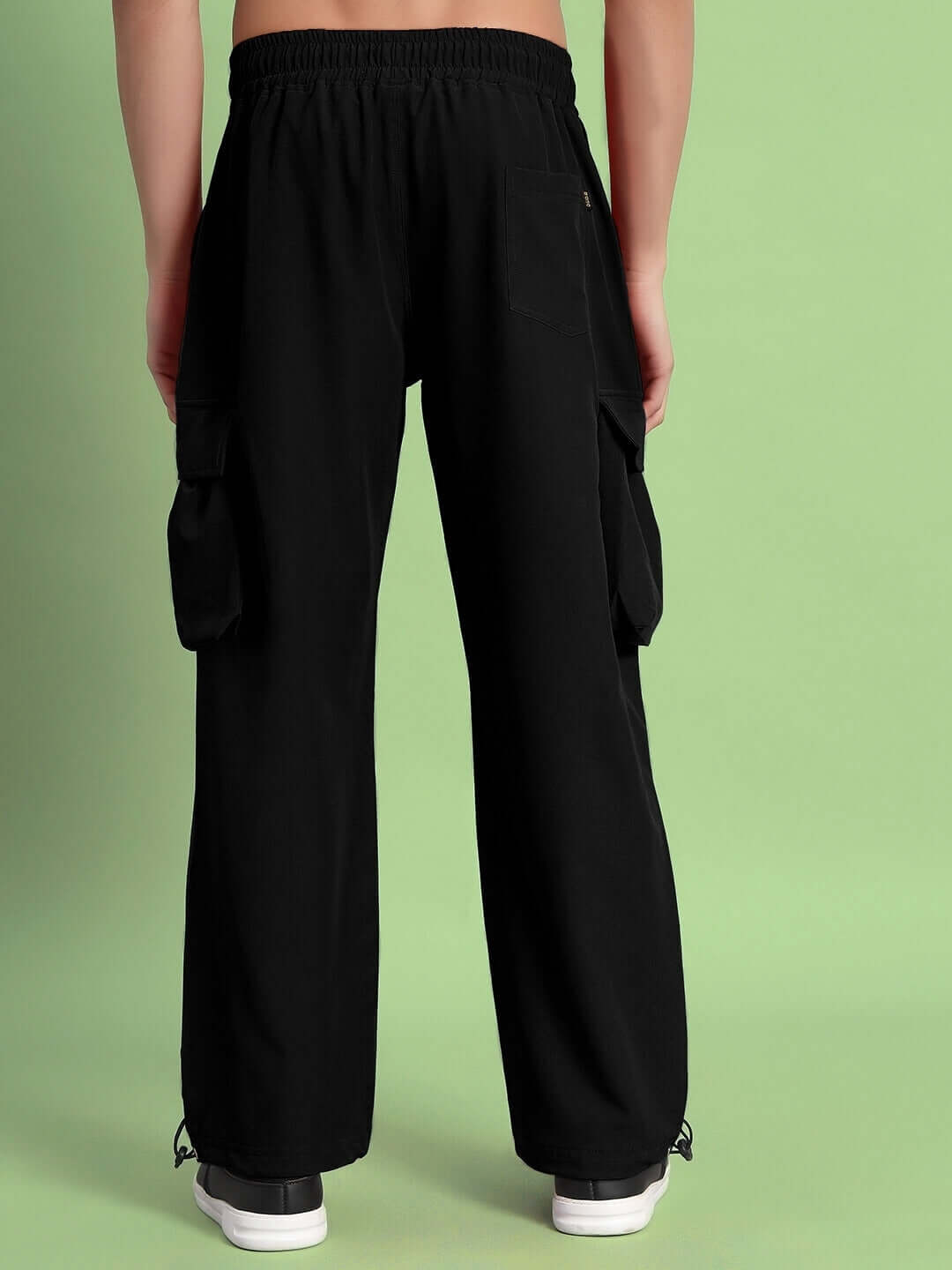 Back view of black MABEL relaxed fit cargo pants with pockets, ideal for a custom fit option. Perfect blend of style and comfort.