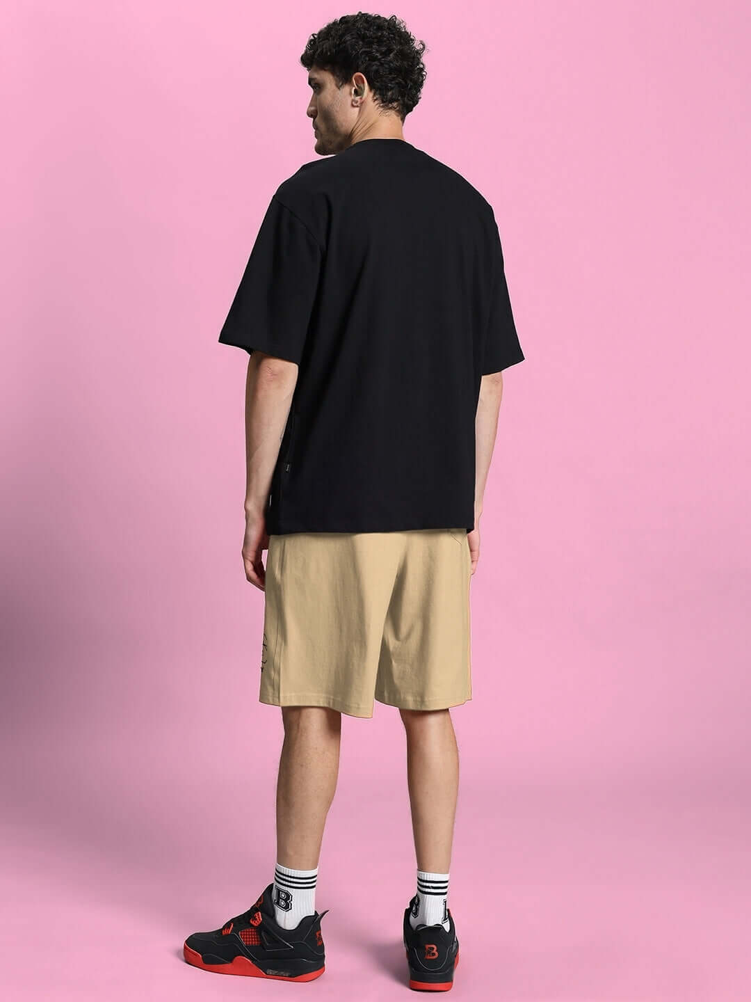 Back view of MAGIC CITY SUMMER CO-ORD SET BLACK BEIGE on model against pink background.