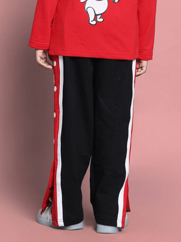 Child wearing black magician jogger pants with red and white side stripes, suitable for boys and girls, made by experienced tailors.