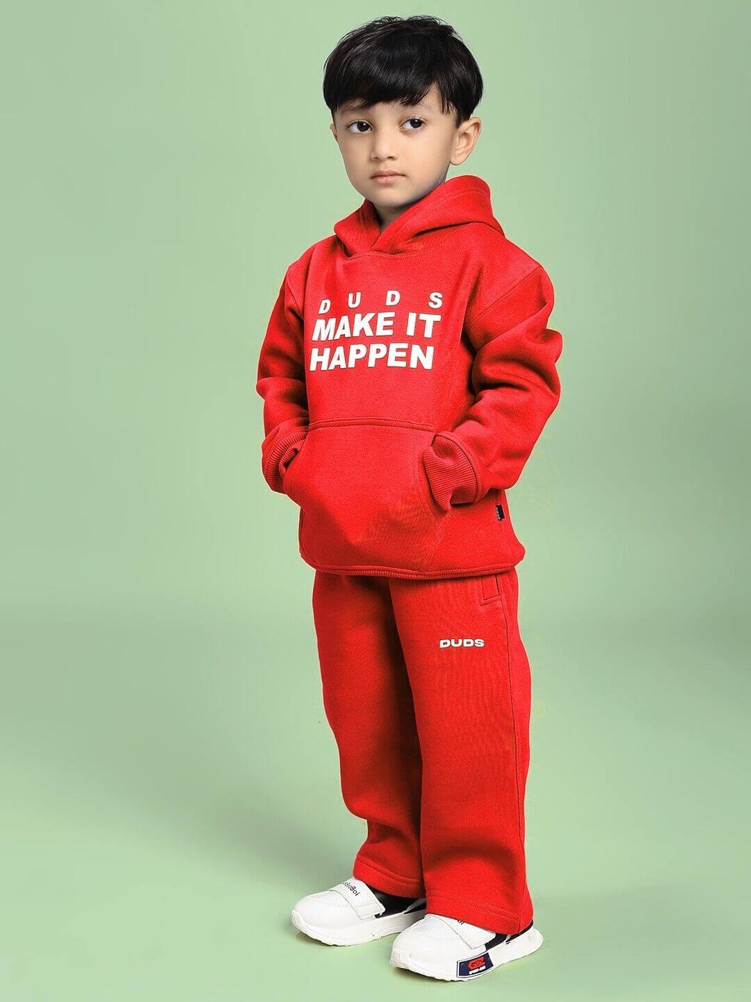Child wearing MAKE IT HAPPEN FLEECE CO-ORD FOR BOYS AND GIRLS RED, featuring vibrant red hoodie and pants with white sneakers.