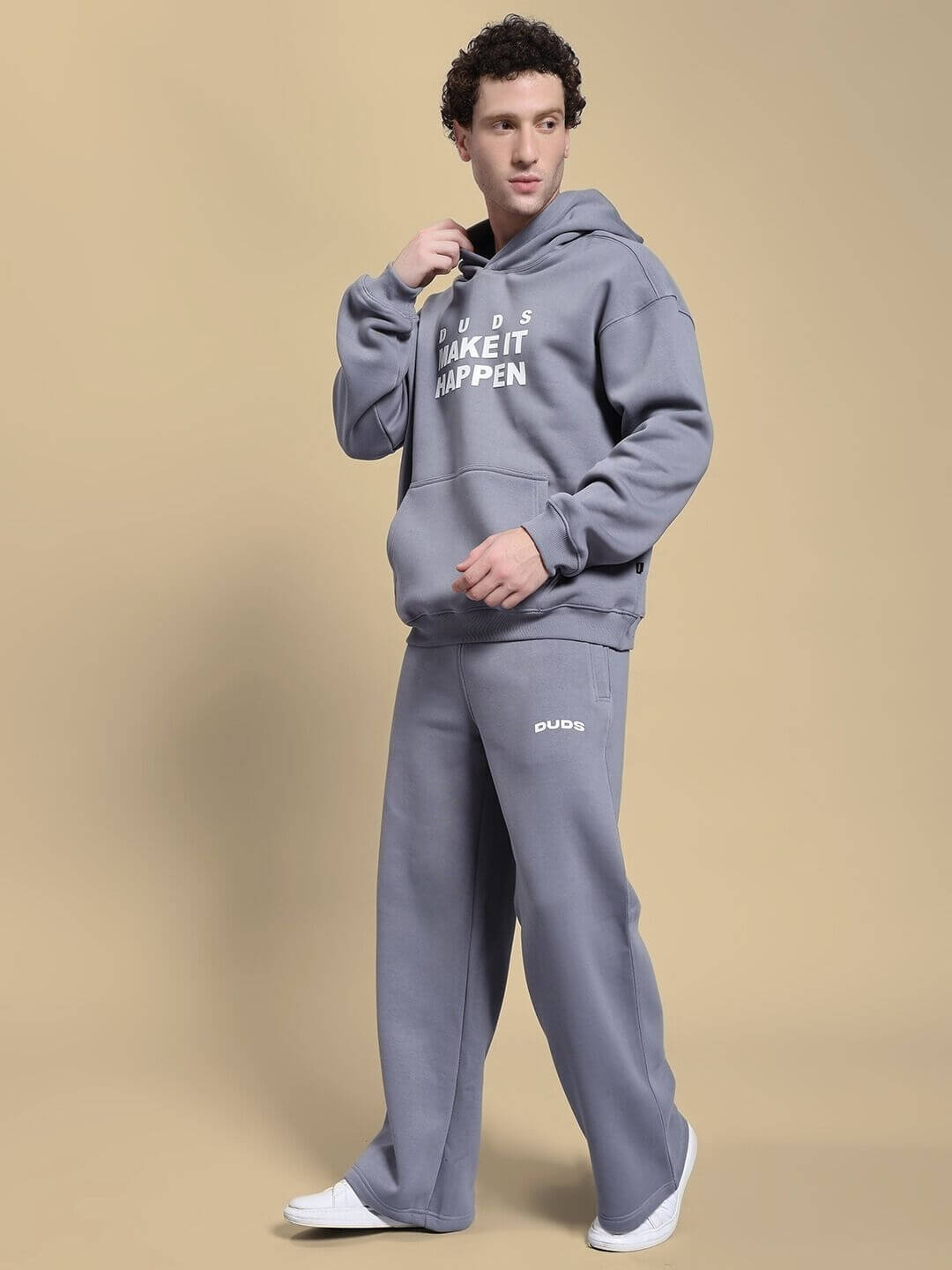 Fashion model wearing MAKE IT HAPPEN FLEECE CO-ORD SET GREY, showcasing comfortable and stylish sweatshirt and joggers outfit.
