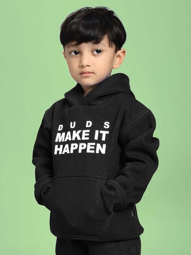 Child wearing MAKE IT HAPPEN FLEECE HOODIE FOR BOYS AND GIRLS BLACK with motivational text, stylish and cozy for everyday wear.