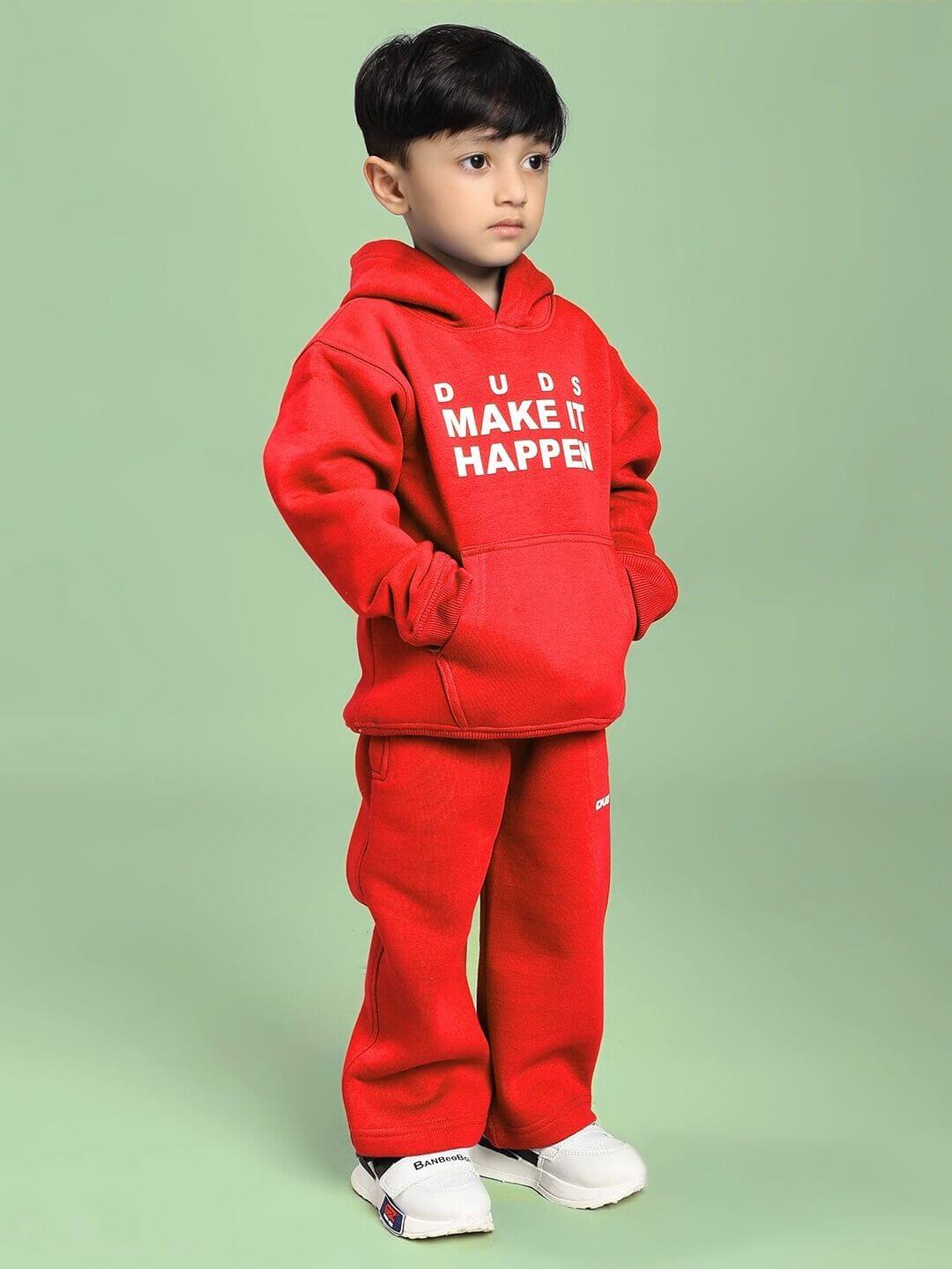 Young child wearing MAKE IT HAPPEN FLEECE CO-ORD FOR BOYS AND GIRLS RED, showcasing bold style and comfort in a playful outfit.