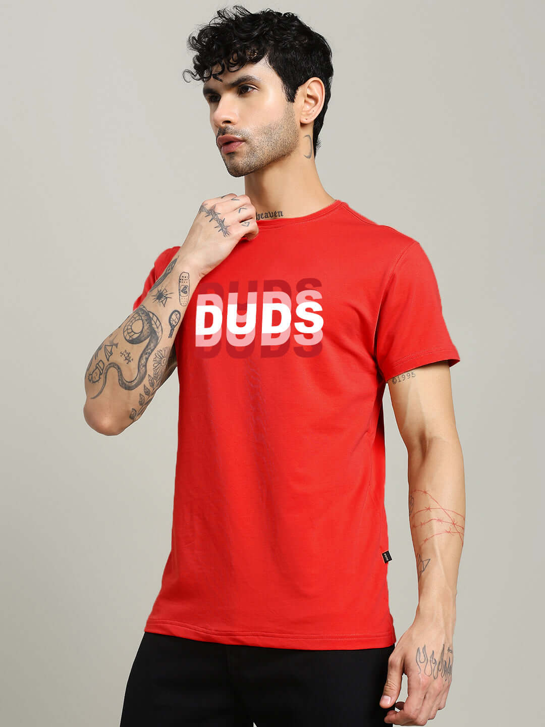Person wearing a MARK REGULAR FIT COTTON T-SHIRT RED with printed design, showcasing a casual look and tattooed arms.