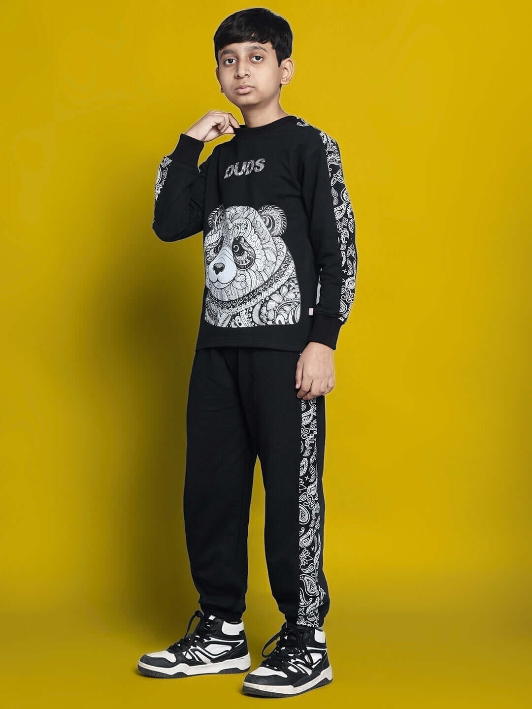 Child wearing black Masha Co-Ord set with bear design, by DUDS, featuring custom fit options for boys and girls.
