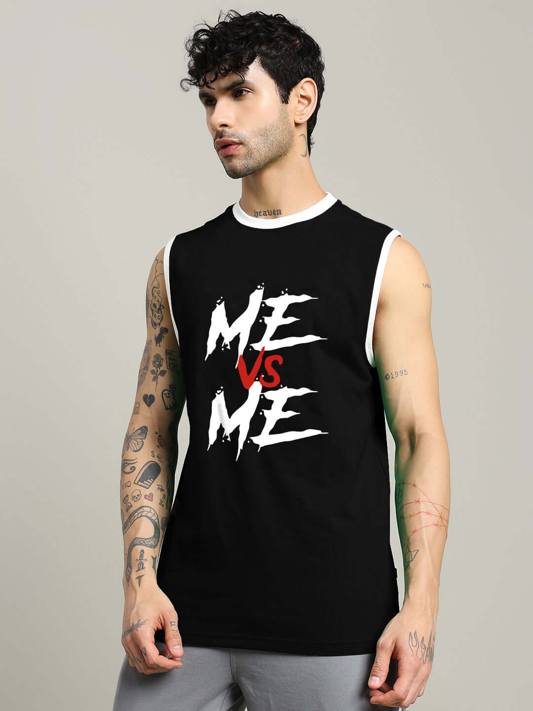 Black "ME VS ME" gym t-shirt worn by model, showcasing fitness apparel style.