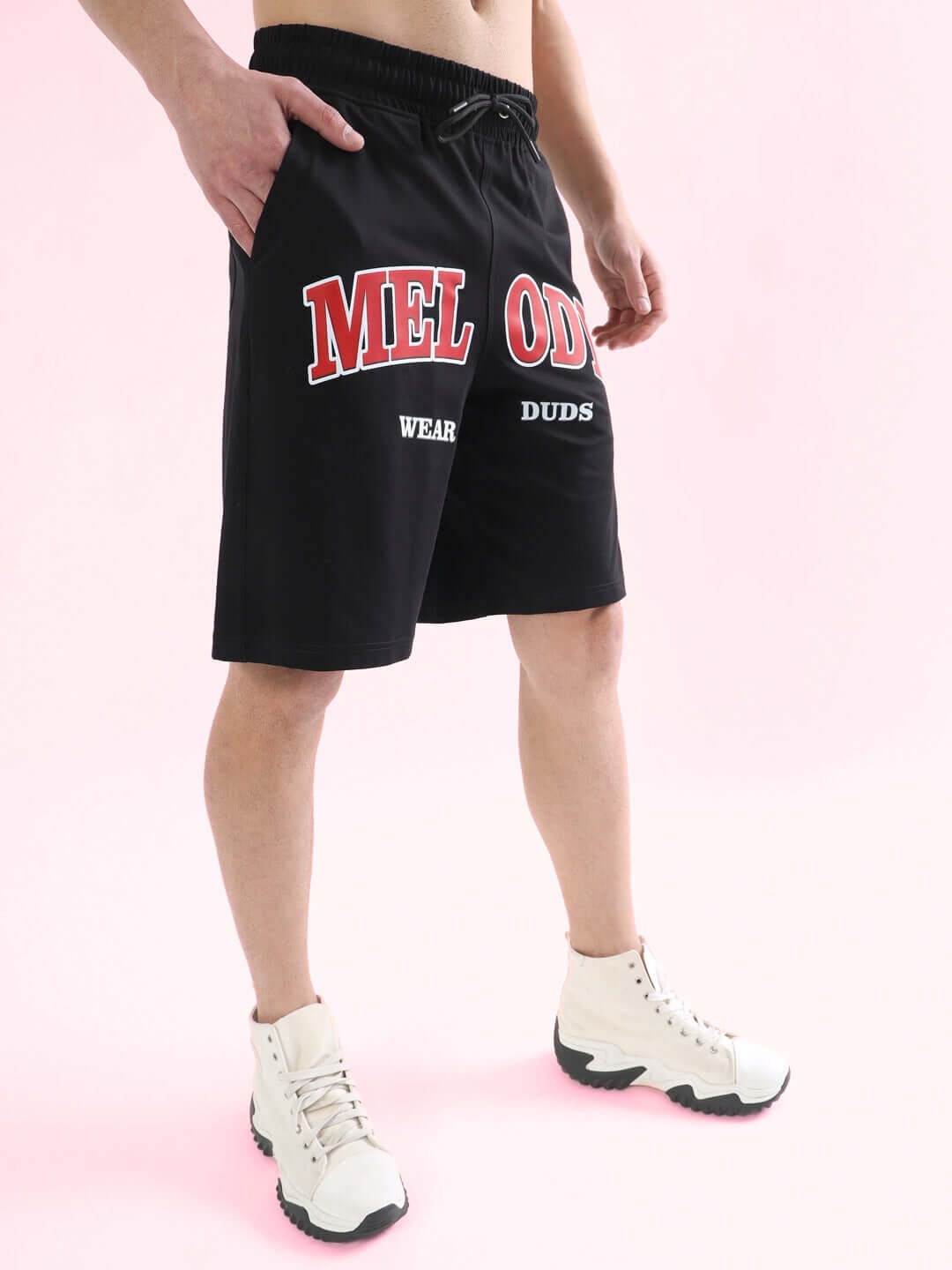 Black Melody Regular Fit Shorts by DUDS, featuring customizable sizing options for a perfect fit, shown on model with white sneakers.