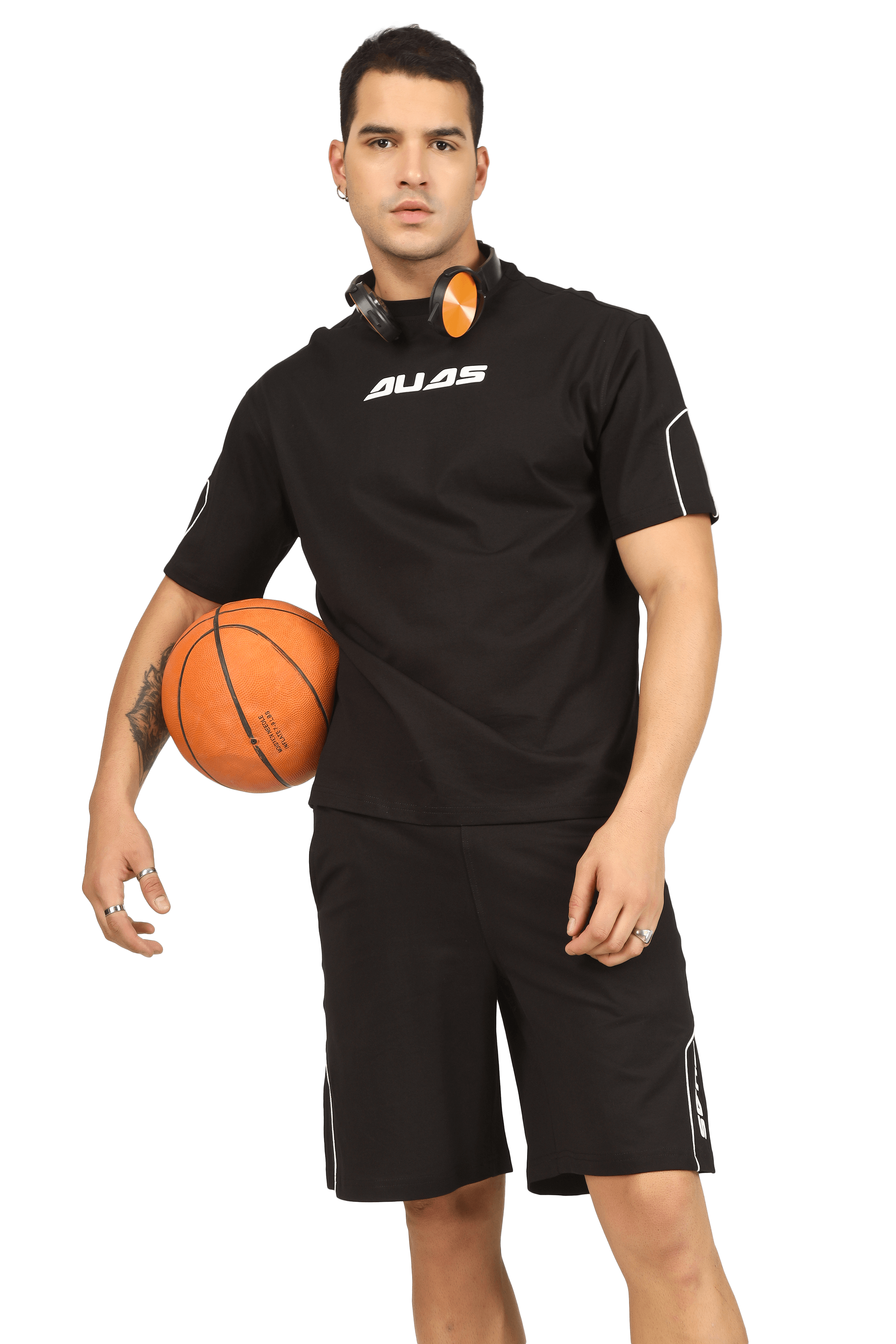 Man in black DUDS sportswear holding a basketball, showcasing the Minimal Shaped Cord Co-ord Set.