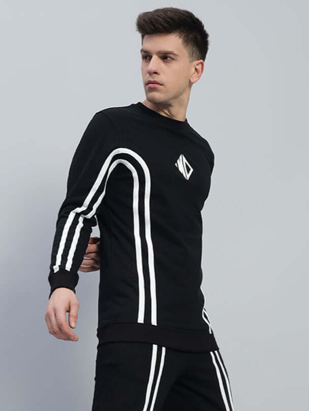 Model wearing OUTLOOK black sweatshirt made of premium cotton French terry lycra, featuring stylish white stripes, comfortable fit.