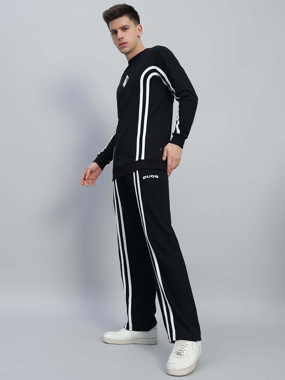Unisex black co-ord set with white and red contrast panel and elastic waistband, perfect for a relaxed fit and customizable comfort.