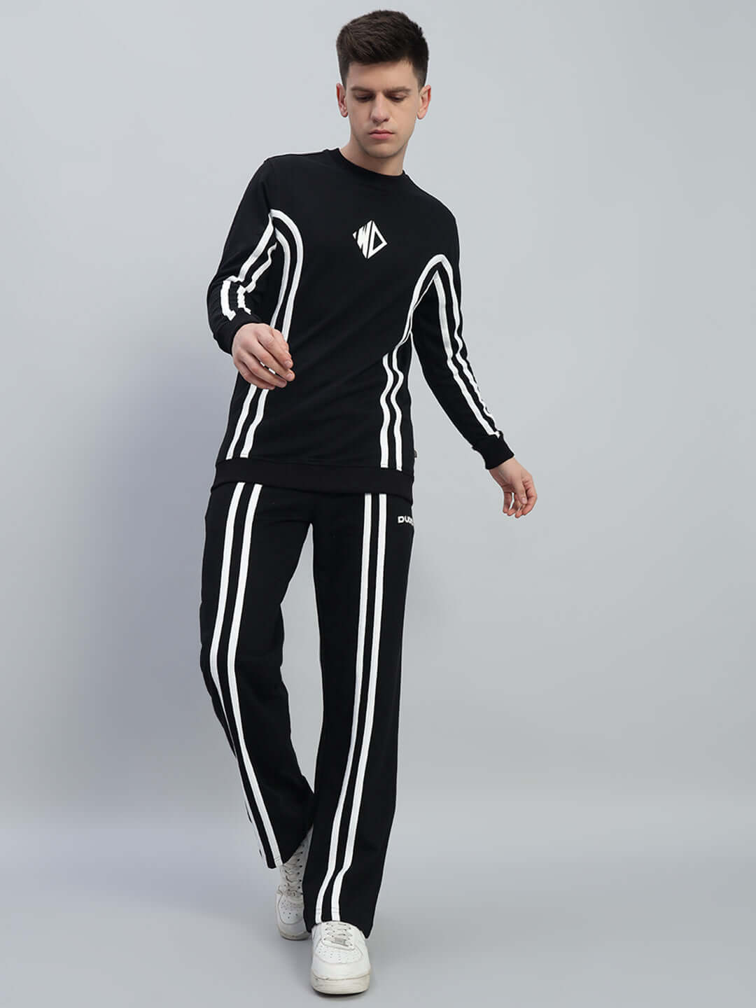 Model wearing OUTLOOK CO-ORD SET in black, featuring relaxed fit joggers with red & white contrast panels, ideal for unisex styling.