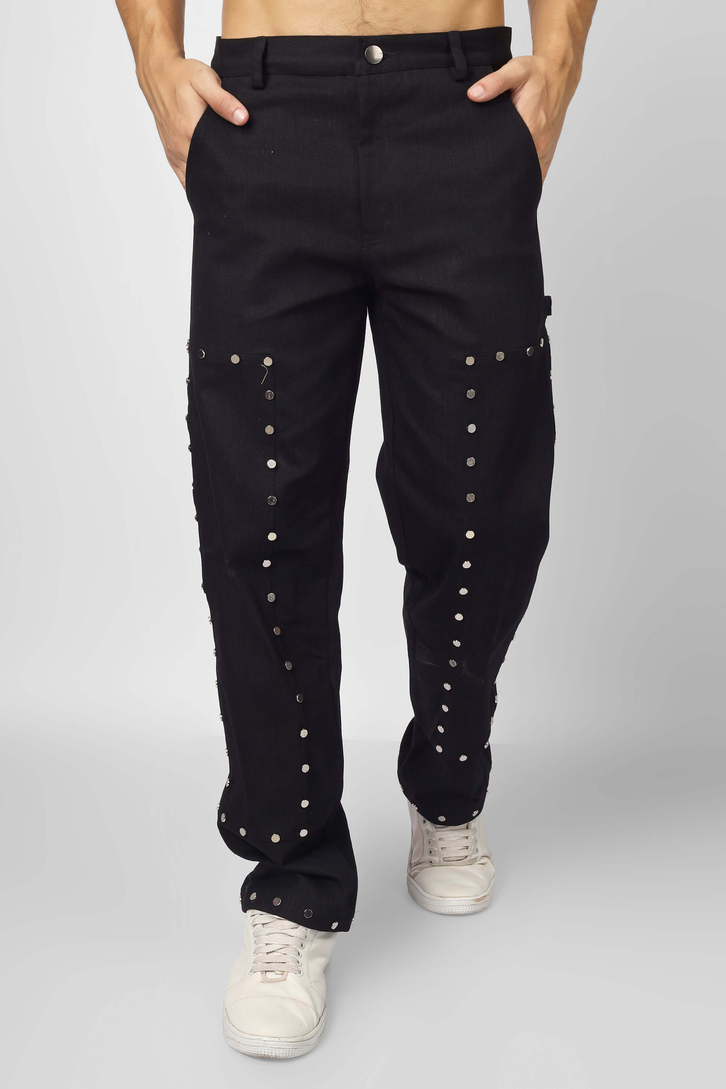 Model wearing black 7 pocket multi metal stud button pants made from durable cotton twill, showcasing edgy fashion style.