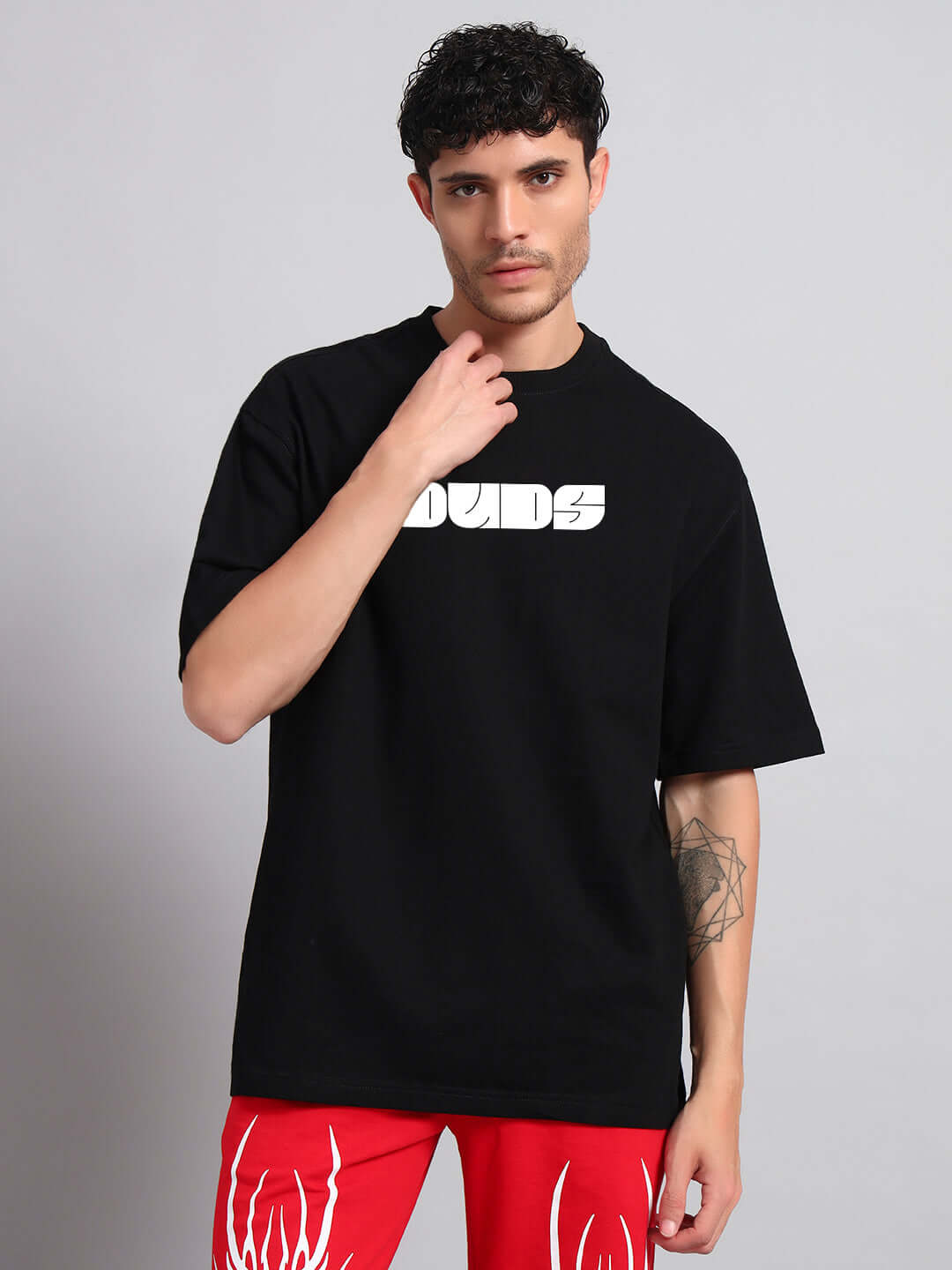 Man wearing black Guns and Roses oversized t-shirt with logo.