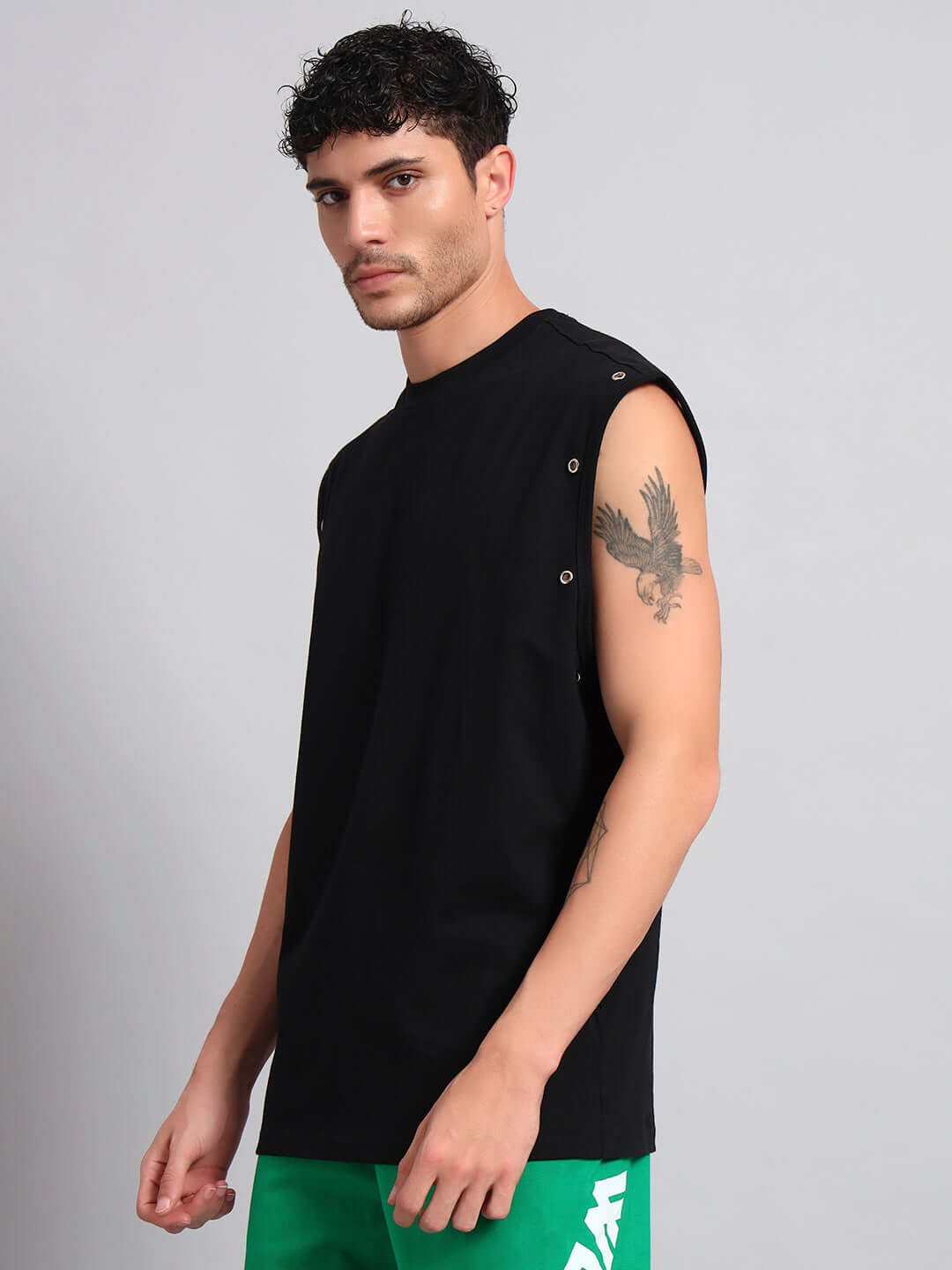 Model wearing ALVEN OVERSIZED T-SHIRT BLACK with side buttons, showcasing casual fashion