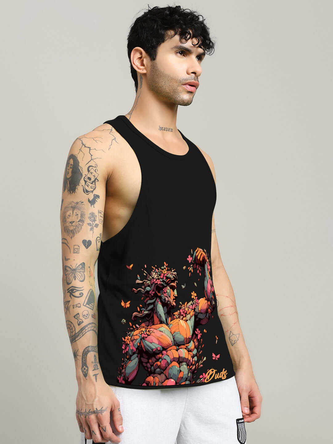 Man wearing a black Classical Greek gym t-shirt with bold graphics, featuring tattoos and a casual style. Available in custom fit options.