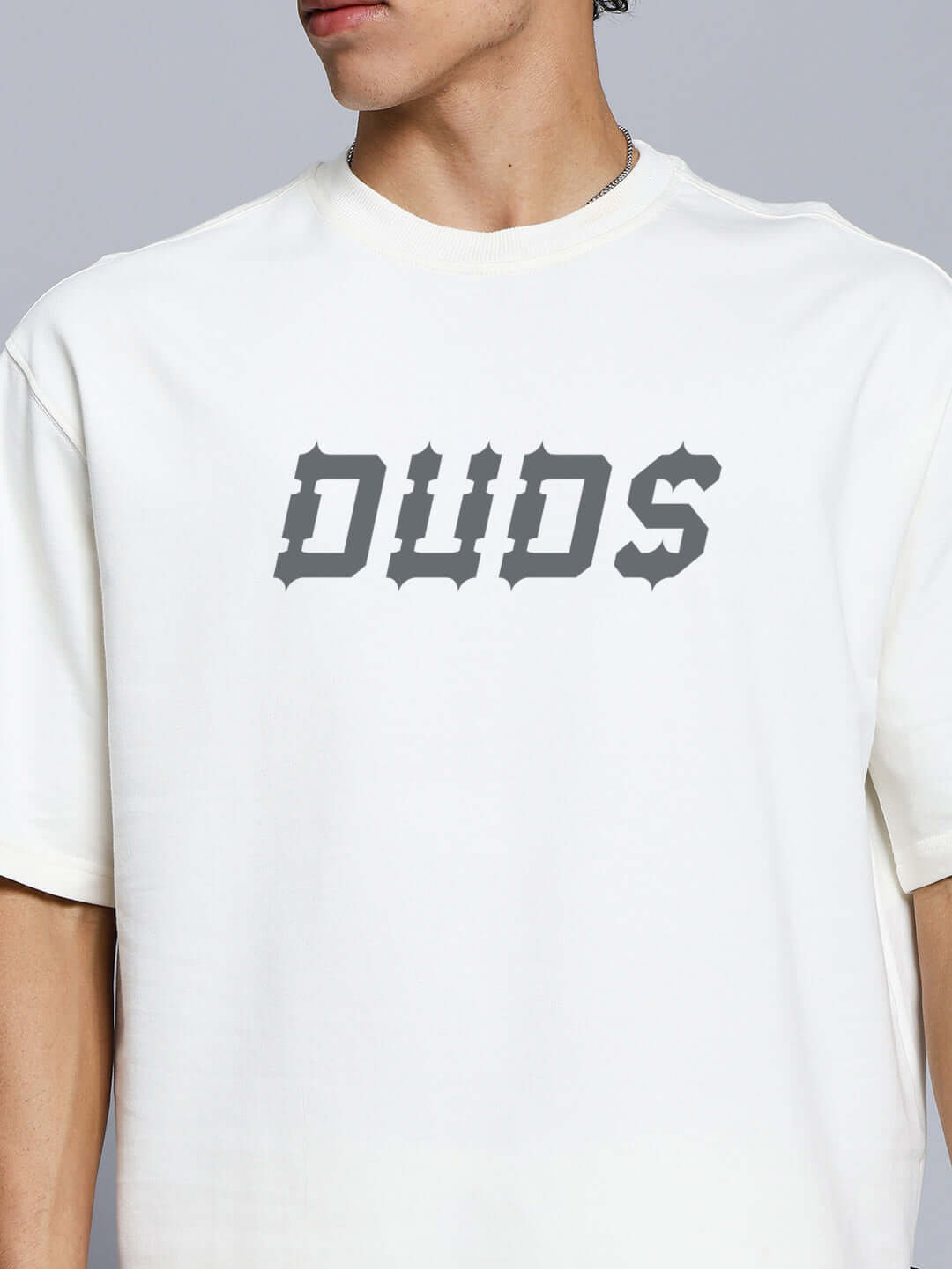 Model wearing Messi Paisley Print Co-Ord Set Off White featuring 'DUDS' graphic on t-shirt.