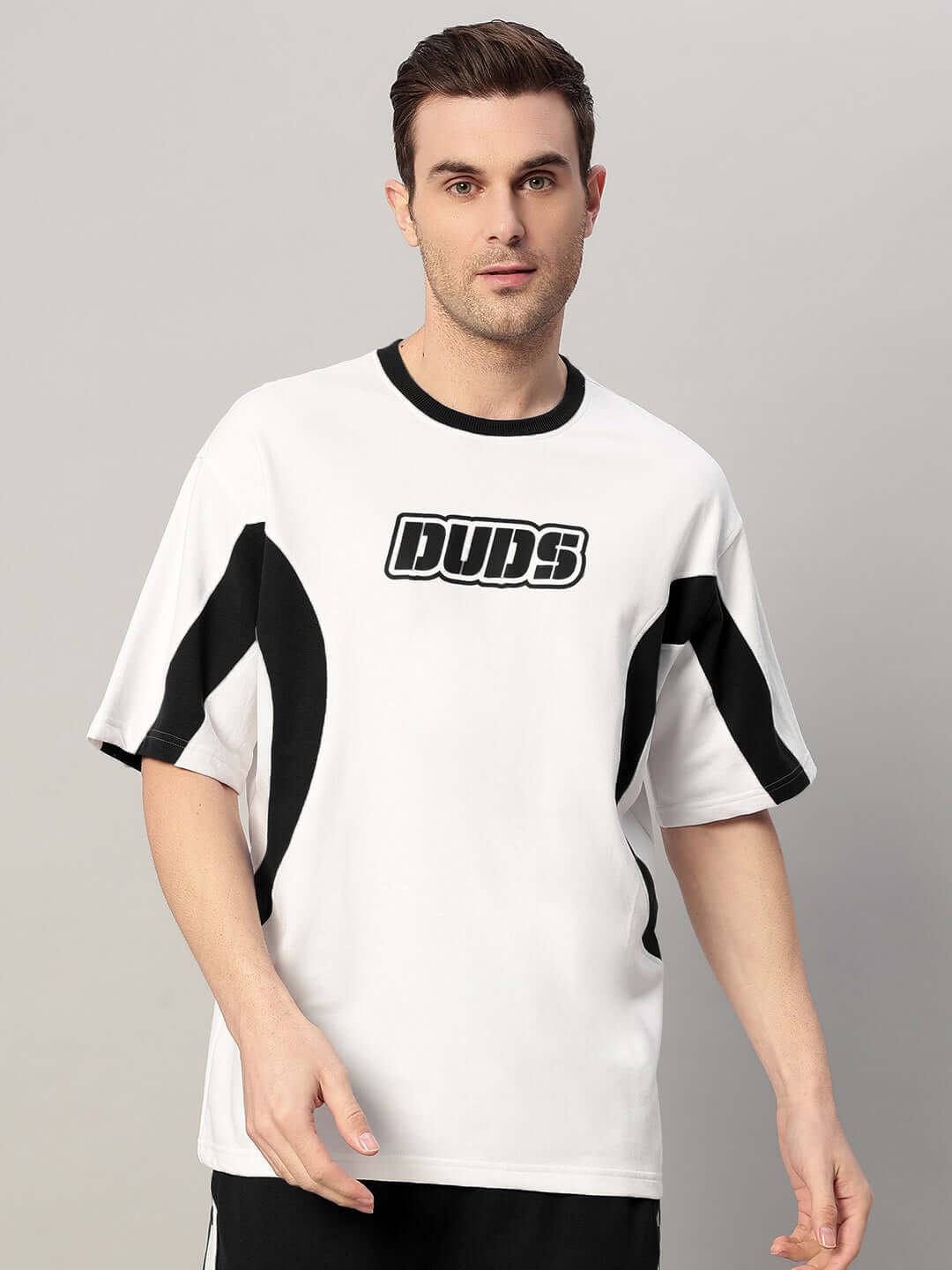 Model wearing EZEL RELAXED FIT CO-ORD SET WHITE-BLACK, showcasing stylish and comfortable monochrome design for off-duty looks.