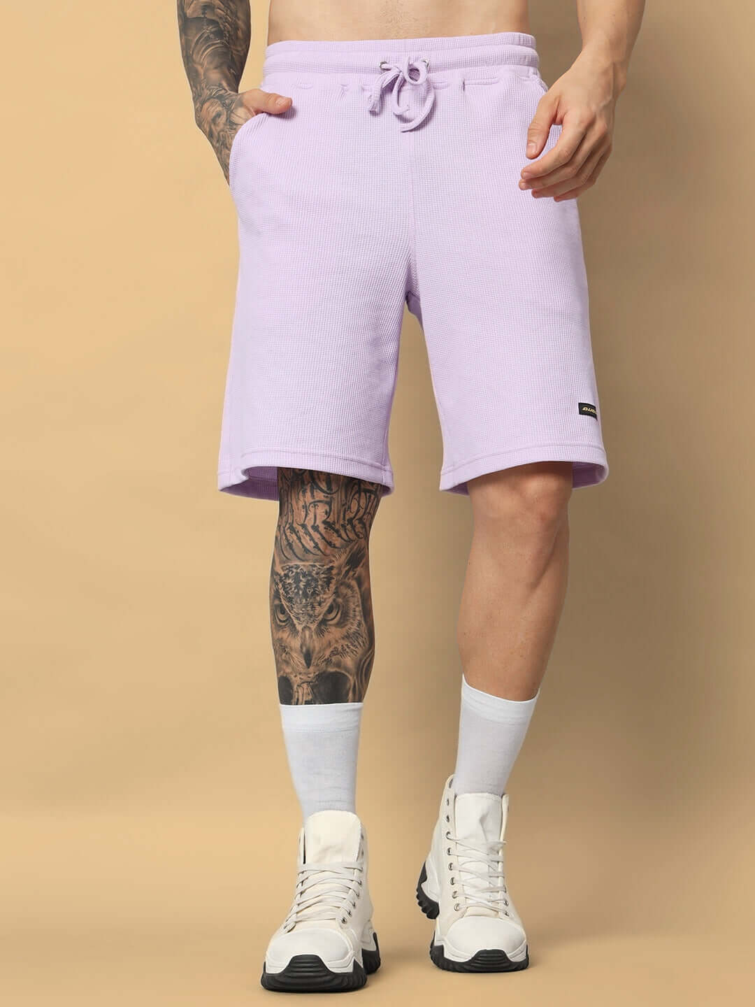 Man wearing a lilac MERCY solid co-ord set, waffle fabric cotton shorts, and white sneakers; relaxed fit; model height 6 feet.