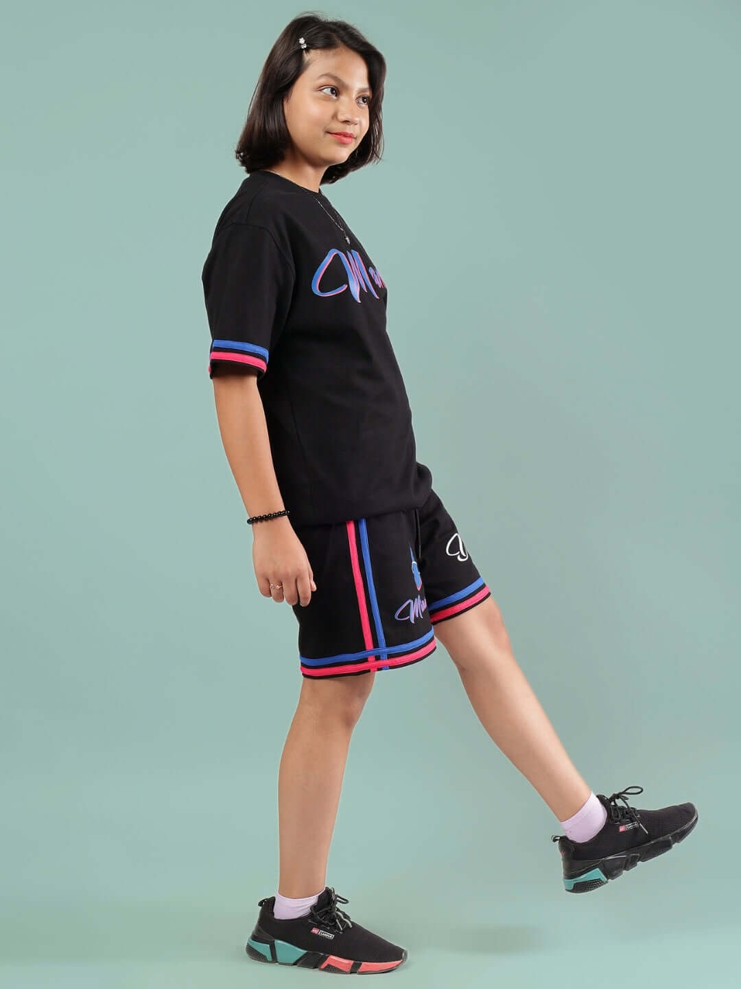 Youth wearing MIAMI CO-ORD FOR BOYS & GIRLS BLACK outfit, featuring black top and shorts, custom fit available for prepaid orders.