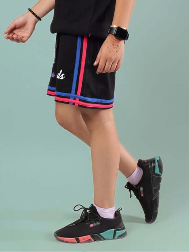 Child wearing MIAMI SHORTS FOR BOYS & GIRLS BLACK with colorful stripes, showcasing style and comfort. Suitable for custom sizes and distinguishing design.