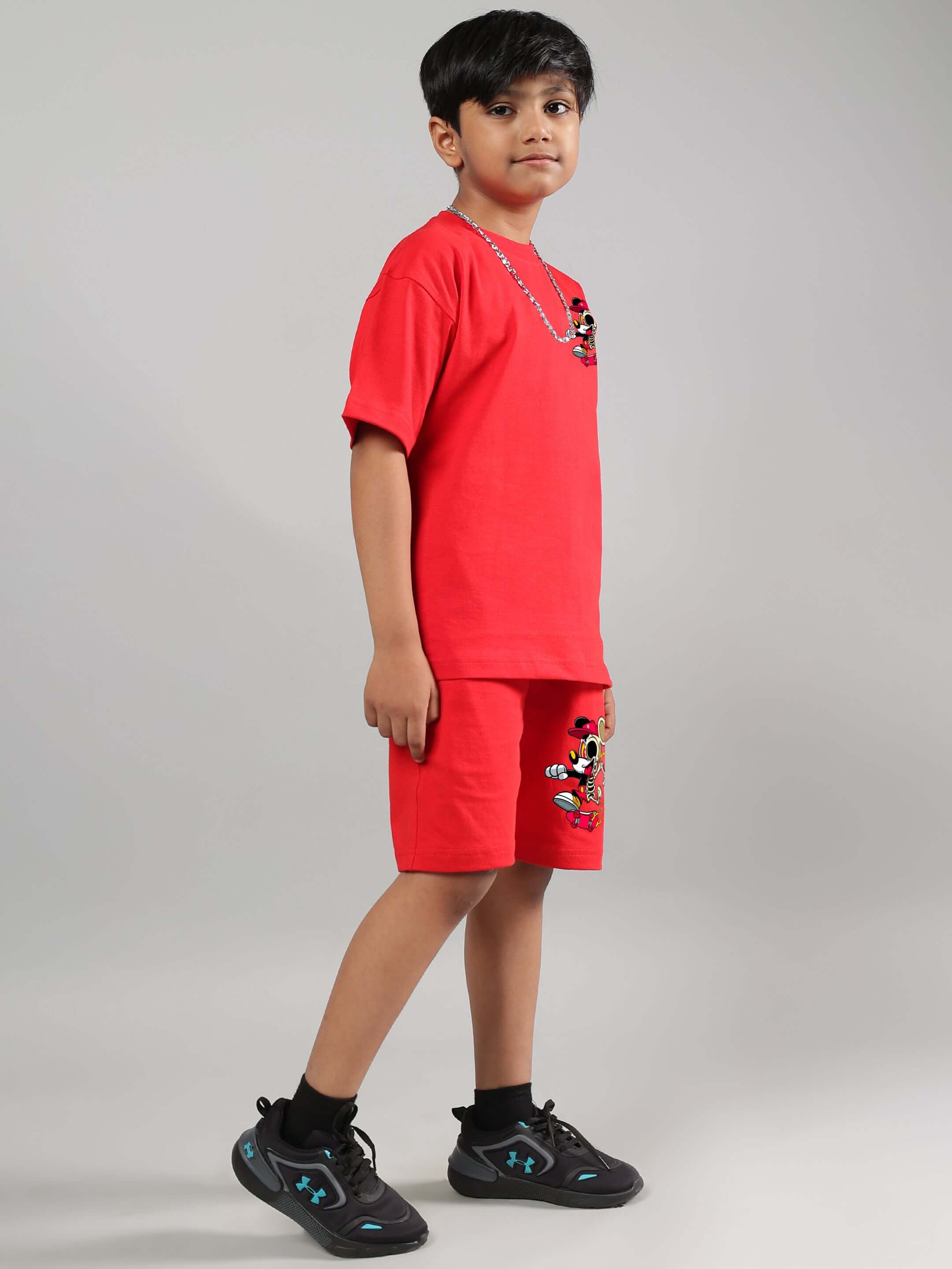 Child wearing red Mickey Mouse summer co-ord set for boys and girls.