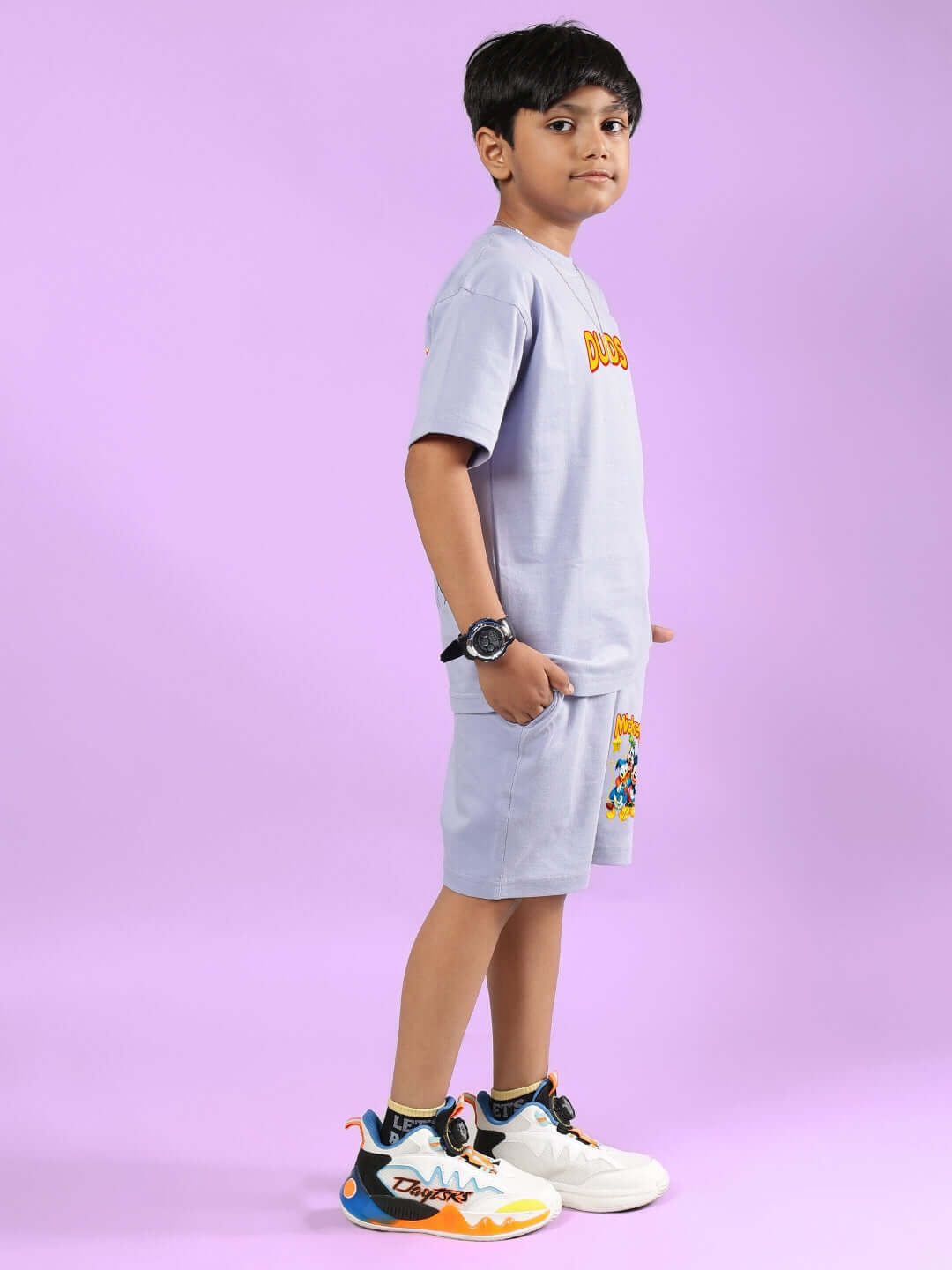 Child wearing MICKEY DINGO CO-ORD FOR BOYS & GIRLS LAVENDER, side view, showcasing design and fit, with colorful sneakers.