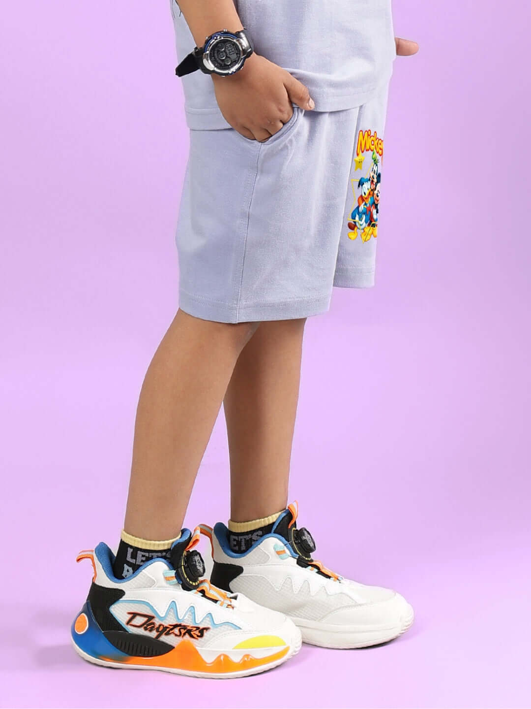 Boy wearing MICKEY DINGO SHORTS FOR BOYS & GIRLS LAVENDER, featuring Mickey Mouse design, stylish casual outfit for children.
