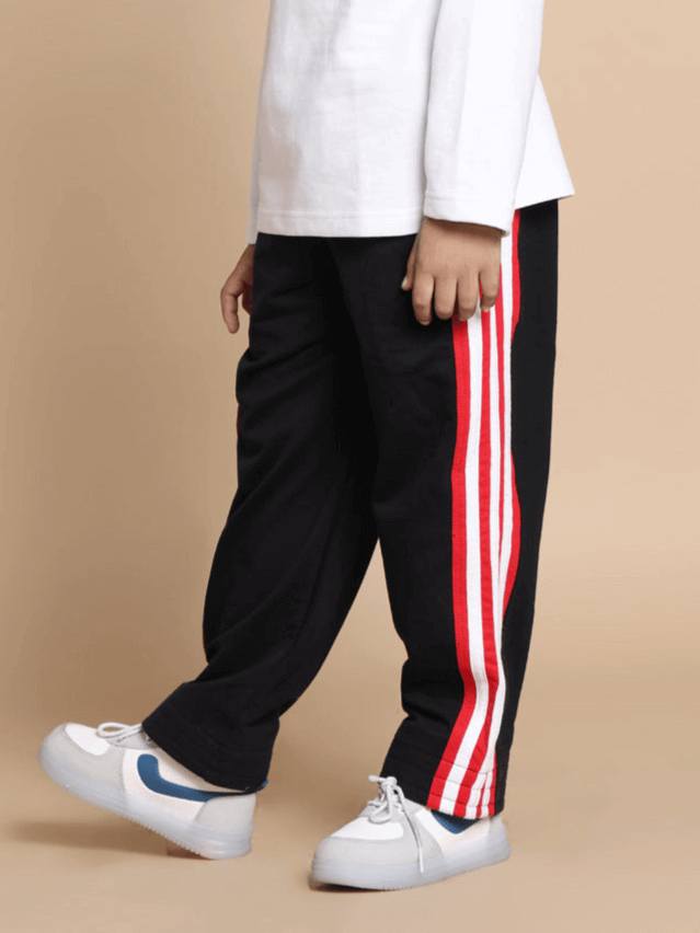 MILANO RELAXED PANT FOR BOYS & GIRLS JOGGER BLACK RED Child wearing JIMMIE oversized co-ord set in white and black with red and white joggers, elastic waistband, showcasing side view.